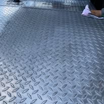 Oxidized, dull diamond-plate aluminum truck bed toolbox before metal polishing in Dublin, TX