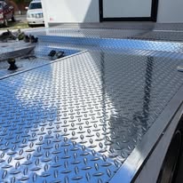 Bright, mirror-polished diamond-plate aluminum truck bed after Texas Car Detail metal polishing