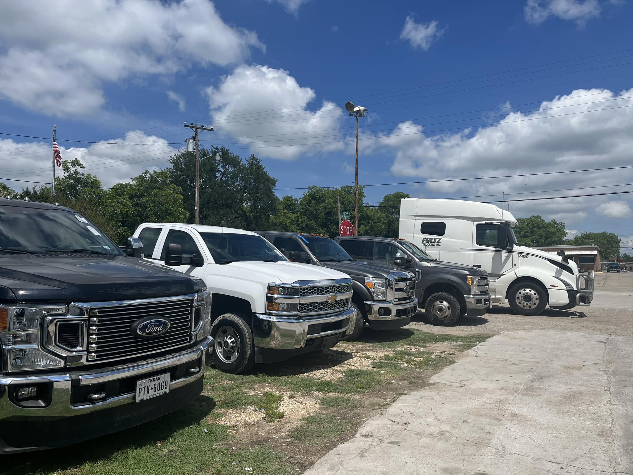 Customer trucks and a semi truck parked at Texas Car Detail in Dublin, TX
