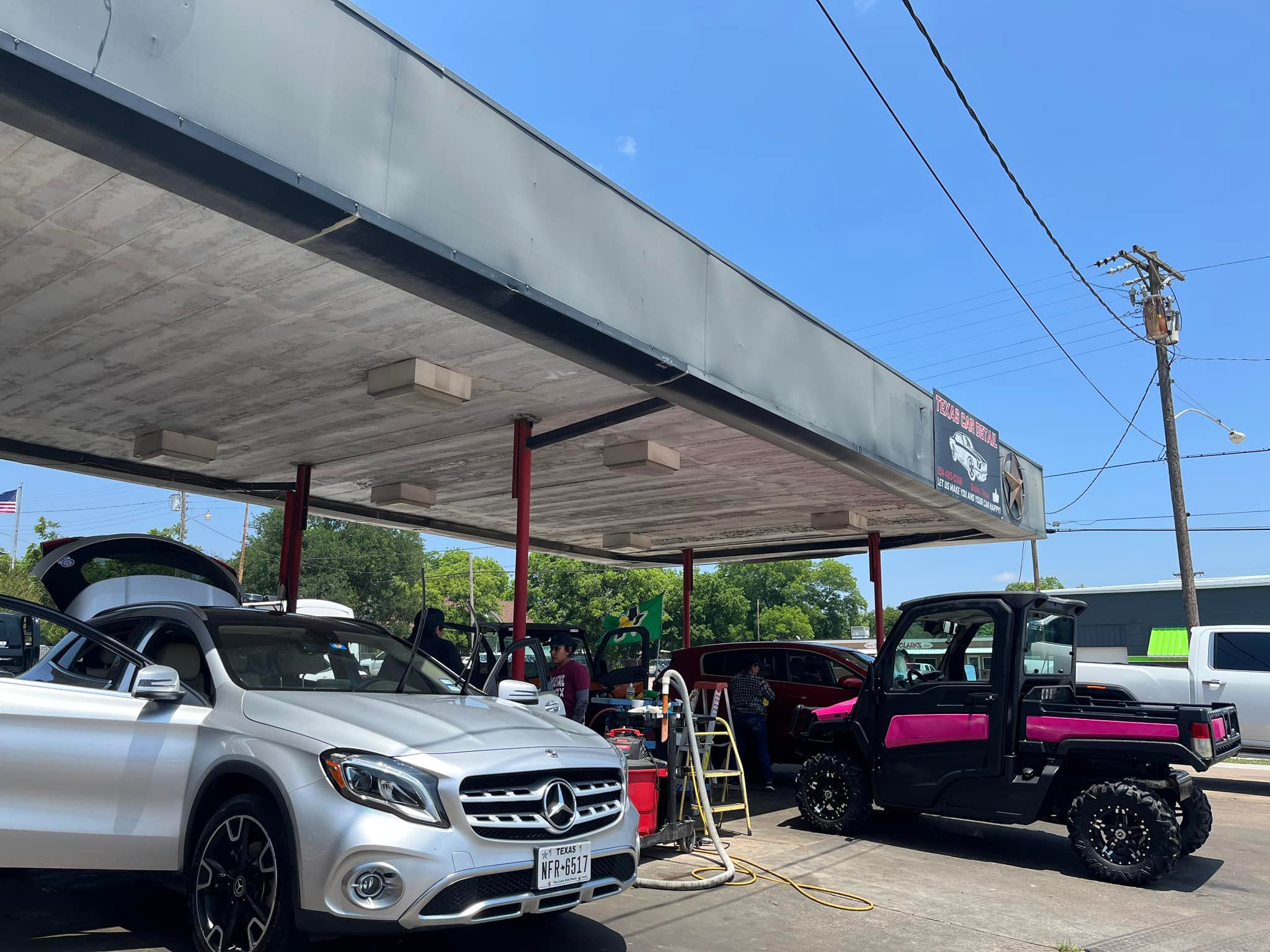 Vehicles receiving hand wax and detailing under the canopy at Texas Car Detail in Dublin, TX